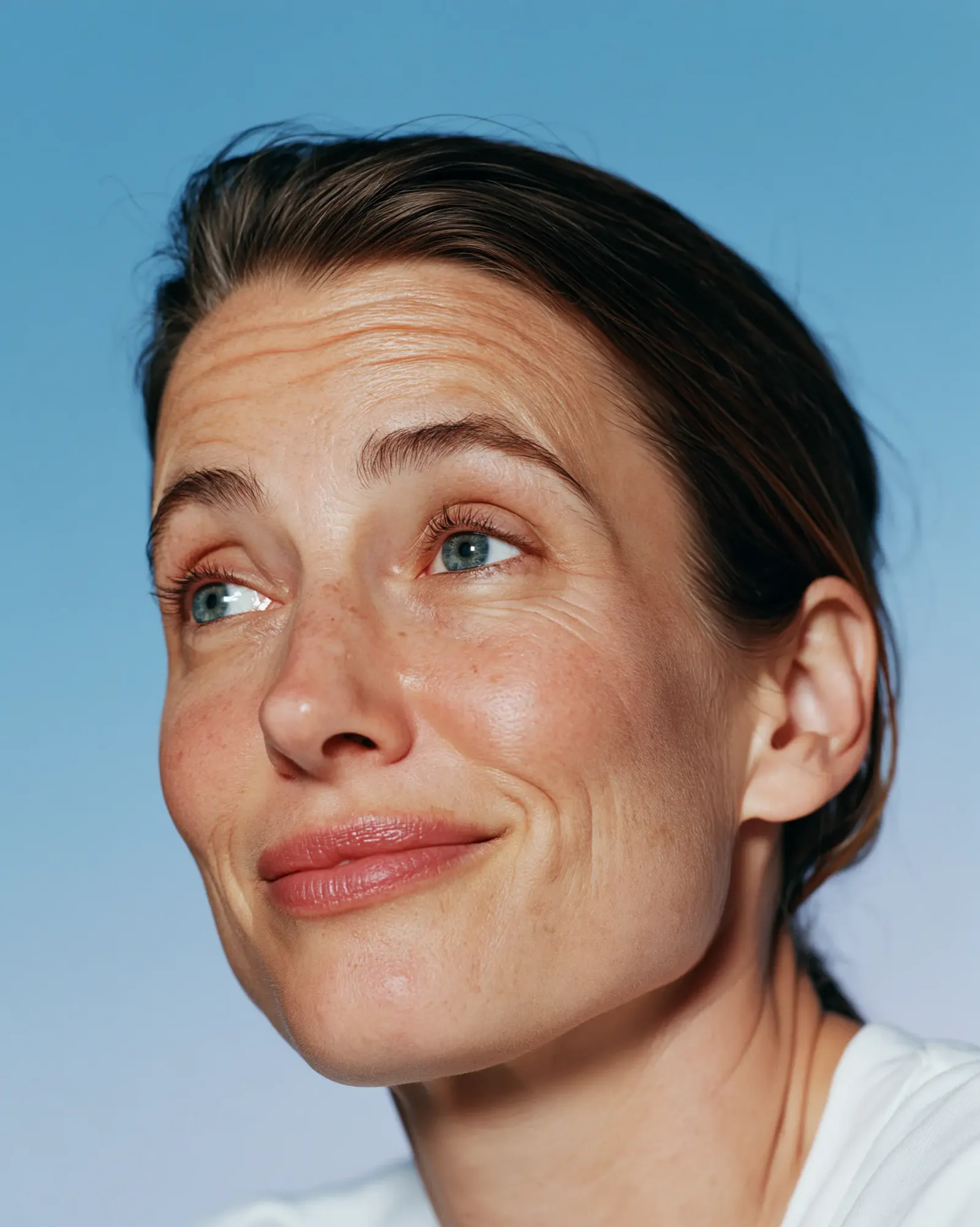 Woman raising her eyebrows showing forehead lines and dynamic facial muscle movement